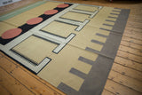 Interlocked geometric kilim pattern with black shapes, madder root red circles.