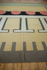 Contemporary kilim carpet with ivory, sand, and black abstract geometric patterns.
