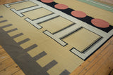 Hand woven kilim with abstract sand, black, ivory, and madder red geometric patterns.