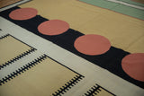 Abstract geometric black comb design on sand and ivory vintage kilim.