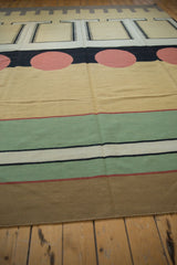 Contemporary kilim rug detail showing horizontal stripes in sand, pale emerald, ivory, and jet black.