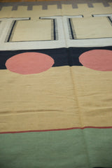 Contemporary kilim rug detail: madder root red circle, jet black, and sand abstract design.