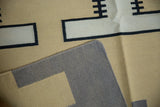 Hand woven contemporary kilim corner, showing flat weave, gray foundation, and geometric pattern.