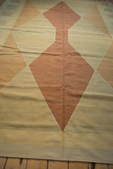 Hand woven Kilim rug with modern geometric argyle pattern in copper, sand, and beige.