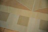Close-up of contemporary Kilim carpet, showcasing geometric copper, sand, and beige blocks.