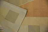 Kilim flatweave texture in copper, sand, and beige, with intact original side cord selvage.