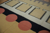 Interlocking geometric elements and overlapping madder root red circles on the vintage kilim rug.