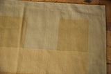 Fine, soft wool texture in pale gold and beige alternating kilim blocks with abrash.