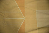 Detail of modern geometric Kilim, soft wool texture, pale copper and beige abrashes.