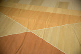 Modern Kilim carpet detail: Argyle-inspired diamond shapes in pale copper, beige, and gold abrashes.