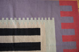 Contemporary Kilim runner detail: abstract stepped border in terracotta and dusty royal blue.