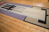Contemporary Kilim runner's flat weave side edge with geometric lavender, beige, and black blocks.