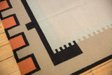 Abstract contemporary Kilim rug with terracotta and black geometric interlocked border detail.