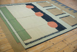 Contemporary kilim showing pale emerald green stripe, silver field, and geometric charcoal border.
