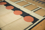 Abstract geometric contemporary Kilim carpet featuring pale brick red circles and charcoal lines.