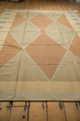 Textural view of the contemporary Kilim's Argyle diamond pattern in pale copper and sand.