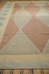 Modern kilim rug featuring argyle copper and sand diamond pattern and striped border.
