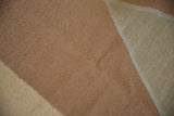 Detail of the contemporary Kilim carpet's flat weave, highlighting copper and sand alternating coloration.