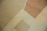 Close-up of contemporary Kilim carpet showing flatweave texture, copper, beige, and sand colors.