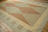 Contemporary kilim carpet detail featuring Argyle-inspired diamond shapes in beige, sand, and copper.