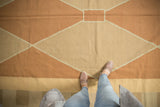Modern Argyle Kilim rug with pale copper and beige diamond pattern underfoot.