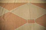 Detail of modern Kilim featuring pale copper and sand Argyle patterns.