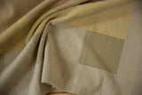 Contemporary Kilim hand-woven texture with folds in beige, sand, and dusty saffron colors.