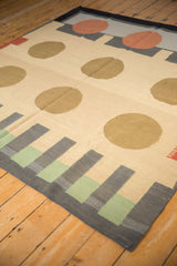 Corner view of a contemporary kilim rug showing geometric charcoal and mallard green stripes.