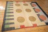 Detail of a vintage contemporary Kilim rug with abstract cinnabar red, charcoal, and camel circle pattern.