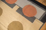 Contemporary Kilim rug features pale terracotta rust circle, sand and charcoal geometric forms.