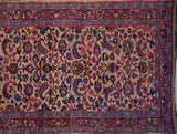 Allover palmettes, botehs, and vinery on the beige field of a vintage Meshed rug.