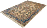 Angled view of a vintage Kerman carpet, showing floral sprays on an ivory field and a prominent sapphire blue border.