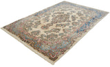 Angled view of the entire vintage Kerman carpet, highlighting its Rococo-inspired floral pattern.