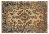 Vintage Kerman carpet with a floral medallion, ivory field, and sapphire blue and rose border.