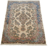 Full angled view of a vintage Kerman rug with intricate millefleur and Rococo designs.