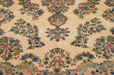 Rococo-inspired millefleur bouquets in blue and dusty rose on the carpet's ivory field.