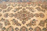 Rococo-inspired floral bouquets and medallion detail on the ivory pile of a fine Persian Kerman.