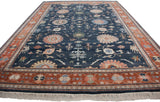 Indian Bijar carpet corner with terracotta border, dark denim blue palmettes, and soft ivory fringe.
