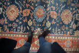 Terracotta and ivory border of vintage Indian Bijar carpet with floral design.