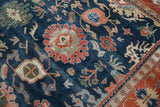 Large terracotta palmette and intricate vinery on dark denim blue field, Bijar design.
