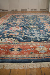 Terracotta and navy border with intricate geometric patterns and ivory fringe on vintage Bijar carpet.
