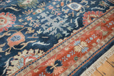 Traditional Indian Bijar carpet corner displaying terracotta border, navy field with palmettes, ivory fringe.