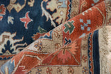 Rolled vintage Indian Bijar carpet edge with terracotta, navy, ivory palmettes and full pile.