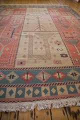 Beige pictorial panel with pale terracotta and oxidized copper green motifs on a Soumac carpet.