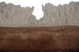 Thick plush dark beige pile, ecru fringe, and original side cord selvage on a vintage rug.
