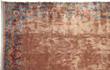 Corner of vintage Indian Arts and Crafts rug, featuring plush beige field and ornate floral border.
