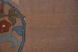 Close-up of thick pile with red, blue floral arabesques on Indian Arts and Crafts rug.