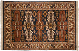Vintage Kula rug corner with dark navy field, chestnut palmettes, and ivory fringe.