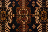 Hand-knotted Kula rug: chestnut medallion, navy field, ivory serrated leaves.