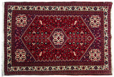 Playful field of birds and germinating plants on a cherry red vintage Persian Abadeh rug.